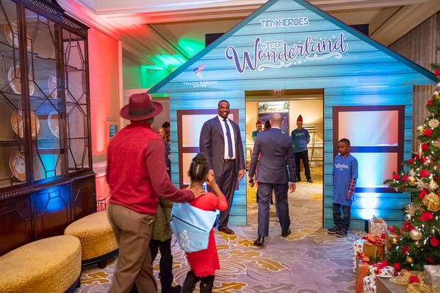 Washington Redskins player Arie Kouandjio welcomes the kids of deployed troops to a Winter Wonderland event. (Yellow Ribbons United)