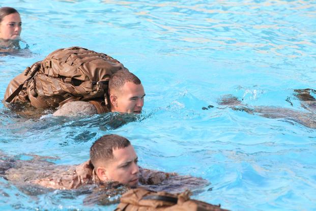 Lance Cpl. Charles Melber, an armory custodian with 9th Communication Battalion, I Marine Expeditionary Force, swims while wearing a full pack during swim qualification at Camp Pendleton, Calif., April 4. (U.S. Marine Corps/Cpl. Joshua Young)