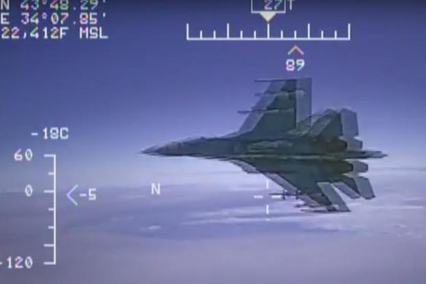A screenshot from the video released by the US Navy showing a Russian Su-27 fly just 5 ft from a EP-3 surveillance aircraft. (Commander, U.S. Naval Forces Europe-Africa/U.S. 6th Fleet/YouTube)