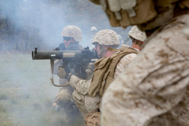 U.S. Marine Corps Lance Cpl. David Coker, center, assaultman, Alpha Company, 1st Battalion, 2nd Marine Regiment, 2nd Marine Division (MARDIV), fires a shoulder-launched multipurpose assault weapon during a platoon live fire attack as part of a deployment for training exercise on Fort A.P. Hill, Va., April 22, 2015. (U.S. Marine Corps photo/Alexander Hill)