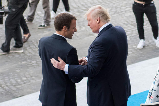 French President Emmanuel Macron welcomes President Donald Trump to the reviewing stand for the Bastille Day military parade in Paris, July 14, 2017. (DoD photo/Dominique Pineiro)
