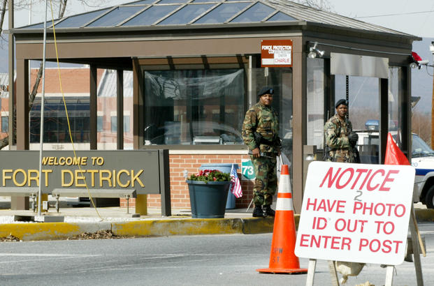 Two soldiers stand guard at the main gate of Fort Detrick in Frederick, Maryland.