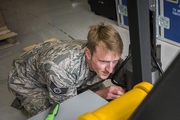 Staff Sgt. Ryan Hoagland, 96th Civil Engineer Group, makes adjustments to gripping arms during the assembly of the explosive ordnance disposal flight’s new robot April 9 at Eglin Air Force Base, Fla. (U.S. Air Force/Ilka Cole)