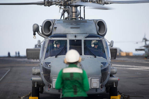 An MH-60R Sea Hawk helicopter assigned to the "Swamp Foxes" of Helicopter Maritime Strike Squadron (HSM) 74 prepares to take off from USS Gerald R. Ford's (CVN 78) flight deck. (Sean A Elliott)