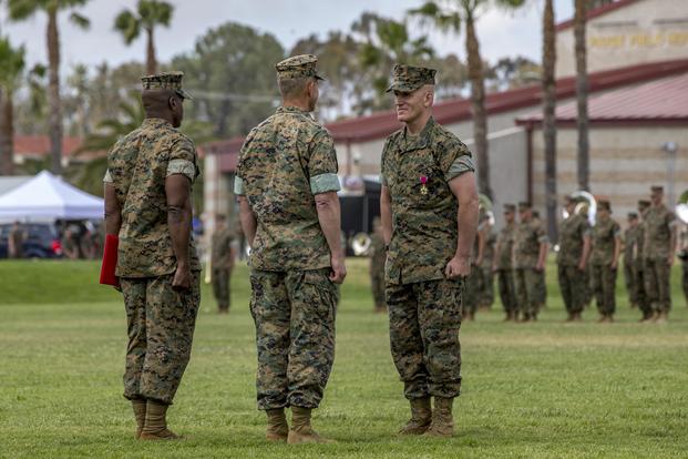 Lt. Gen. Lewis Craparotta, center, the I Marine Expeditionary Force commanding general, awards Sgt. Maj. Bradley Kasal, the outgoing I MEF sergeant major, the Legion of Merit during a relief and appointment ceremony on Camp Pendleton, Calif., on May 18, 2018. (U.S. Marine Corps photo by Lance Cpl. Clare Mcintire)