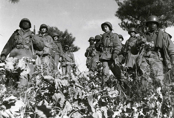 Sgt. 1st Class Elijah McLaughlin (left front) and Cpl. Luther Anderson (right front) lead their squad down a steep hill as they begin a 1,500-yard advance toward another hill northwest of the Ch’ongch’on River, North Korea, Nov. 20, 1950. (Army Heritage Center photo)