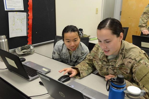 Staff Sgt. Ashlie Robledo and Senior Airman Thao Bui, 11th Special Operations Intelligence Squadron analysts, participate in a data-tagging training event Aug. 24, 2017, at Hurlburt Field, Fla. (U.S. Air Force/Senior Airman Lynette M. Rolen)