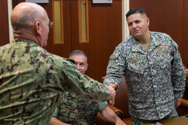 Colombian Naval Infantry Lt. Col. Erick H. Del Rio, the deputy commander of Special Purpose Marine Air-Ground Task Force - Southern Command, right, shakes hands with U.S. Navy Adm. Kurt W. Tidd, the commander of U.S. Southern Command, May 16, 2018. (U.S. Marine Corps photo/Zachary Dyer)