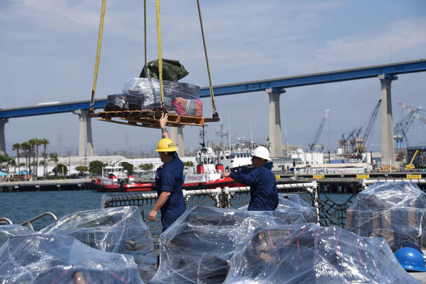 Crew members from the Coast Guard Cutter Steadfast send off a pallet of seized cocaine during an offload at Tenth Avenue Marine Terminal, San Diego, July 16, 2018. The drugs were interdicted from four suspected smuggling vessels from late June to mid-July. (U.S. Coast Guard photo/Fireman Taylor Bacon)