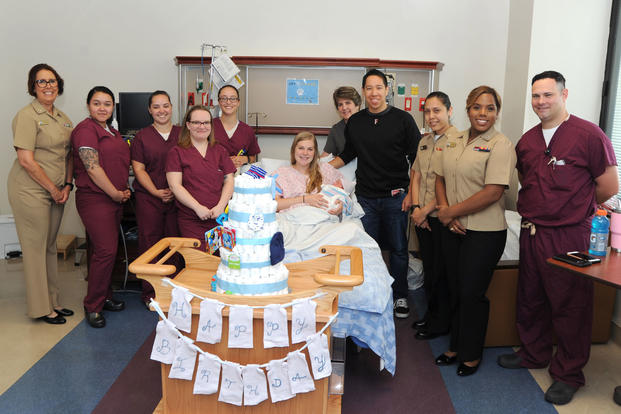 The staff of Naval Hospital Pensacola’s Labor and Delivery pose for a picture with Michaela and Ensign Jacob Bishop, a flight student at Naval Air Station Whiting Field, Florida, and their son James Robert Bishop on June 29. The staff presented the family, who delivered the last baby at NHP, with a diaper cake made up of 156 diapers. As of July 1, labor and delivery services will no longer be available at NHP. (U.S. Navy photo/Jason Bortz)