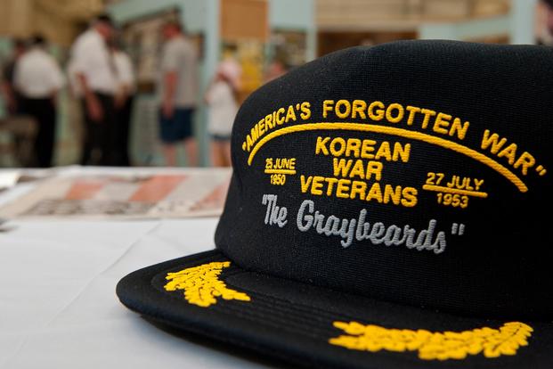 A Korean War veteran hat sits on a table.