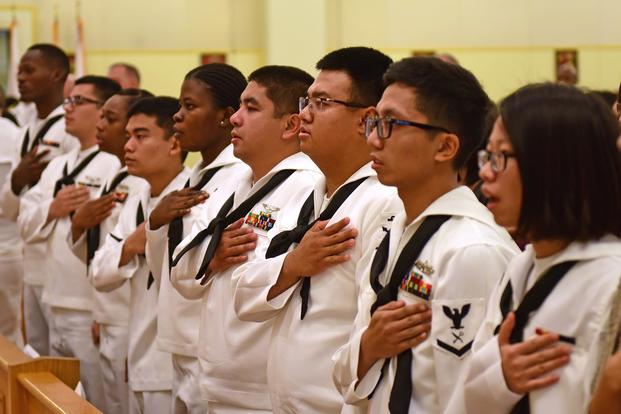 Participants in the naturalization ceremony recite the Pledge of Allegiance. (U.S. Navy/Mass Communication Specialist Seaman Timothy D. Hale)