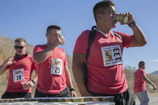 Marines hydrate at the water station during the 5th Battalion, 11th Marines Turkey Trot Holiday 5k race aboard Camp Pendleton, Calif., Nov 18, 2017. (U.S. Marine Corps/Pfc. Drake Nickels)