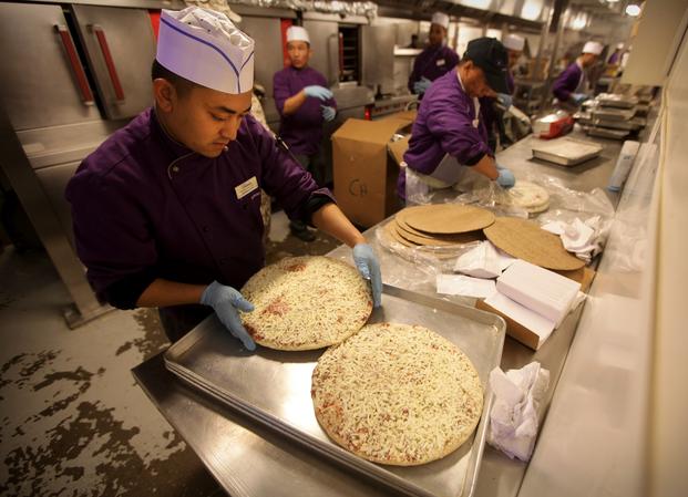 Dining facility workers aboard Camp Leatherneck cook pizzas in preparation for Super Bowl XLVII Feb. 4, 2013. The pizzas were provided by Pizza4Patriots, a nonprofit organization, whose mission is to provide service members with a "slice" of home while they are deployed. (Bobby J. Yarbrough, U.S. Marine Corps)