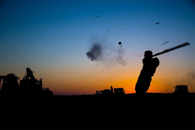 U.S. Army Pfc. Michael Gilreath, 3rd Cavalry Regiment, swings an improvised bat during a fun game of baseball near the Iraqi-Syrian border, June 23, 2018. (U.S. Army/Spc. Anthony Zendejas IV)