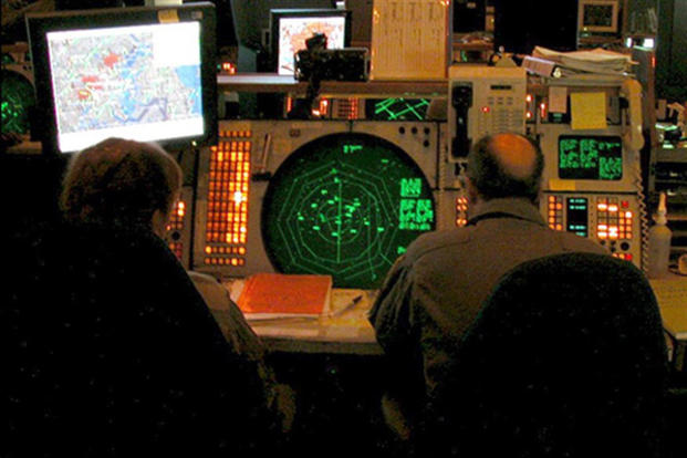 After Sept. 11, 2001, this is what the NEADS operation floor looked like. Above the Q-93 (the large green radar scope) is the NORAD contingency suite that was installed immediately after 9/11 to provide radar data of the entire country. Photo courtesy of Master Sgt. Stacia Rountree, Eastern Air Defense Sector