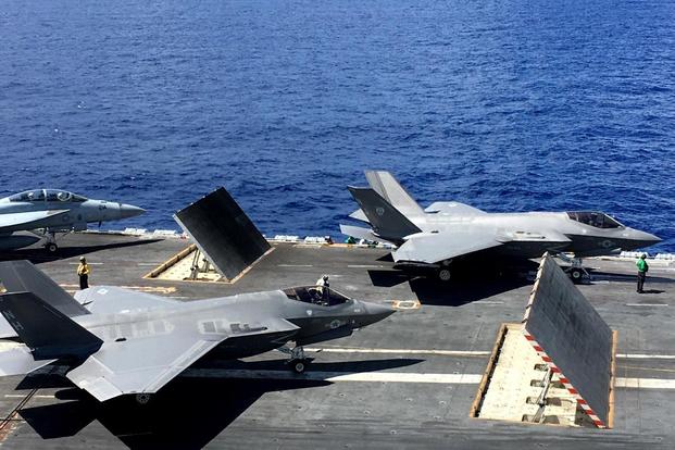 Two F-35Cs and a F/A-18 sit on the flight deck of the carrier USS Abraham Lincoln (CVN-72) on August 27, 2018. (Military.com/Matthew Cox)