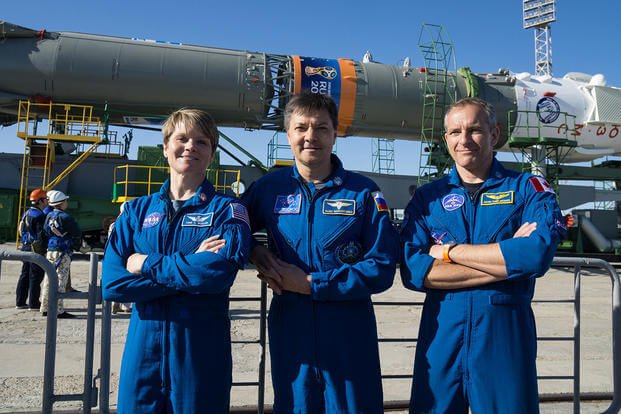 From left, future International Space Station crew members Army Astronaut Lt. Col. Anne McClain, with U.S. Army Space and Missile Defense Command/Army Forces Strategic Command; Oleg Kononenko, with the Russian space agency Roscosmos; and David Saint-Jacques, with the Canadian Space Agency, pose for a picture as a Soyuz rocket arrives at the launch pad June 4, 2018, at the Baikonur Cosmodrome in Kazakhstan. (U.S. Army photo)