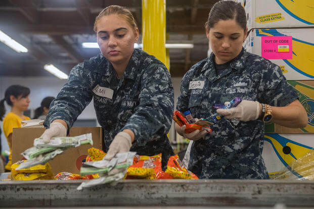 Sailors sort donated food during a community relations event at the Los Angeles Regional Food Bank during Los Angeles Fleet Week, 2018. (U.S. Navy/Danielle Baker)