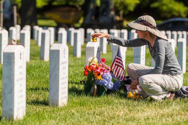 Alison Malachowski tends to the grave of her son, U.S. Marine Corps Staff Sgt. James Malachowski, in Section 60 of Arlington National Cemetery, July 22, 2015. Staff Sgt. Malachowski was killed by an improvised explosive device during his fourth combat deployment on March 20, 2011, while his unit was raising the Afghanistan national flag over a small compound near Patrol Base Dakota in Marjah Province. (U.S. Army/Ken Scar)