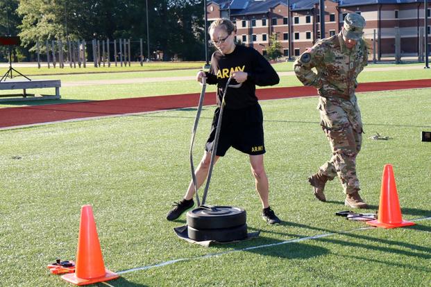Capt. McKenzie Hensley demonstrates the 90-pound led drag portion of the sprint-drag-carry event of the Army Combat Fitness Test. (Military.com/Matthew Cox)