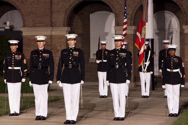 A parade staff with Marine Barracks Washington, D.C., stands in their position during a Friday Evening Parade at the Barracks May 31, 2013. (Dengrier Baez/Marine Corps) 