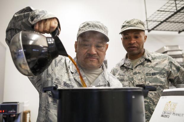 Tech. Sgt. Carlos Ramon, of the 163d Force Support Squadron, pours a small pot of coffee into a larger container that serves 101 cups, April 2, 2017, at March Air Reserve Base, California. (Air National Guard/Airman 1st Class Crystal Housman)