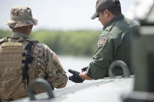 A Texas Guardsman and a Customs and Border Patrol agent discuss the lay of the land April 10, 2018 on the shores of the Rio Grande River in Starr County, Texas. (Texas Military Department/Sgt. Mark Otte)