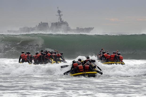 Basic Underwater Demolition/SEAL students participate in surf passage.