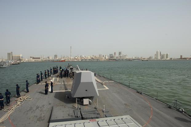 Sailors man the rails as the Arleigh Burke-class guided-missile destroyer USS Nitze (DDG 94) exits Bahrain following a regularly scheduled port visit. (U.S. Navy/Mass Communication Specialist 3rd Class Jeff Atherton)