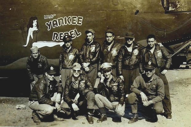  U.S. Army Air Corps 1st Lt. John D. Crouchley, kneeling, second right, and his crew pose for a photo by their B-24 Liberator, “Miss Yankee Rebel” in 1944. Crouchley was assigned to the 828th Bombardment Squadron, 485th Bombardment Group in Foggia, Italy, and went into combat in May 1944. He was killed when his aircraft was shot down over Bulgaria while returning from a bombing mission on June 28, 1944. (Courtesy photo via DVIDS)