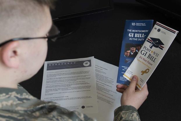 Airman Dalton Shank, 5th Bomb Wing public affairs specialist, reads pamphlets on the Montgomery GI Bill and the Post-9/11 GI Bill at Minot Air Force Base, N.D., on March 10, 2017. (U.S. Air Force photo/Airman 1st Class Alyssa M. Akers)