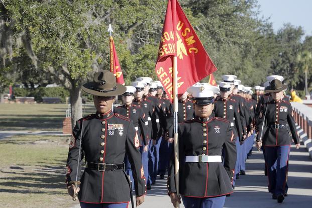 Drill Instructors and Marines with November Company, 4th Recruit Training Battalion march towards the Peatross Parade Deck before their graduation ceremony Nov. 16, 2018 at Marine Corps Recruit Depot Parris Island, S.C. (U.S. Marine Corps/Lance Cpl. Yamil Casarreal)