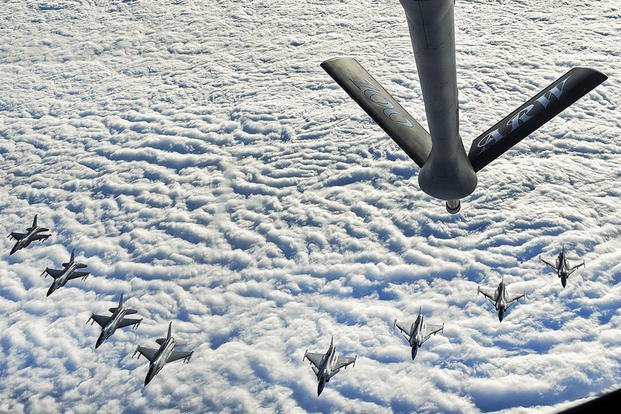 Four U.S. Air Force F-16C Fighting Falcons and four Swedish air force JAS 39 Gripens fly in formation behind a U.S. Air Force KC-135 Stratotanker during aerial refueling training in Swedish airspace, Feb. 8, 2018. (U.S. Air Force photo by Airman 1st Class Luke Milano)