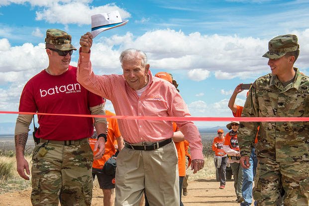 Retired Army Col. Ben Skardon, a 100-year-old Bataan Death March survivor, crosses the 8.5-mile finish line of the Bataan Memorial Death March at White Sands Missile Range, N.M., March 25, 2018. (Army photo by Ken Scar)