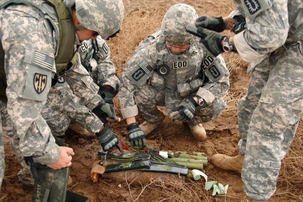 Soldiers prepare old munitions for destruction during controlled detonation operations on Forward Operating Base Delta in southern Iraq, Oct. 31, 2009 (U.S. Army Photo/Staff Sgt. Brien Vorhees)