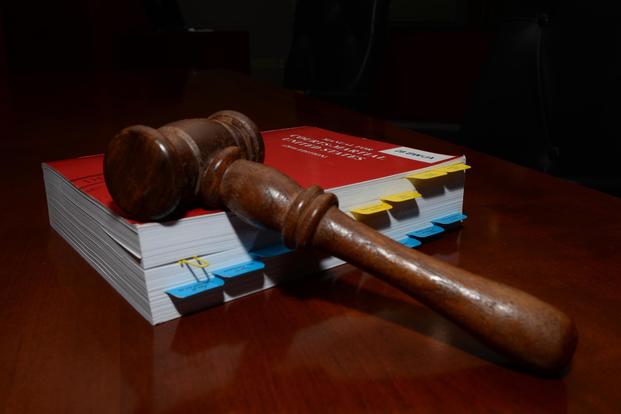 A gavel lays on the Uniform Code of Military Justice inside the 28th Bomb Wing courtroom at Ellsworth Air Force Base, S.D., July 17, 2018. (U.S. Air Force/Airman 1st Class Nicolas Z. Erwin)