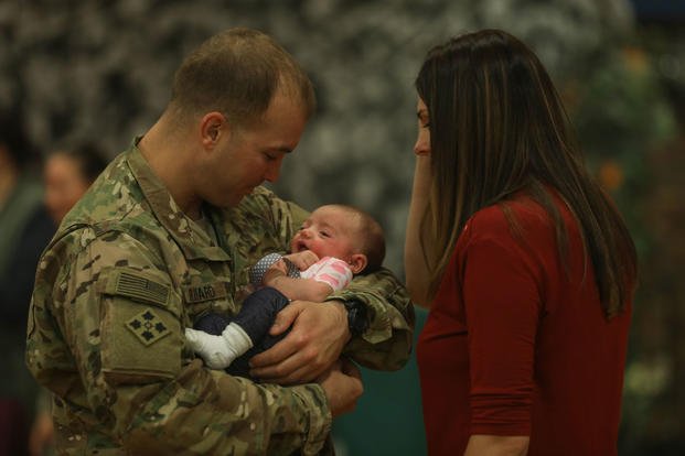 Capt. Harold Rivard is reunited with his daughter, Landry, and wife, Sarah, following a homecoming ceremony at the William Bill Reed Special Event Center, Fort Carson, Colo., Nov. 17, 2018. (U.S. Army photo/Asa Bingham)