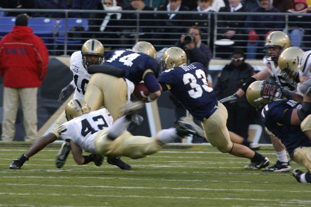 An Army linebacker tackles the Navy quarterback during the 108th annual Army Navy football game in Baltimore, Md. (U.S. Army photo by Mr. Kenneth Drylie)