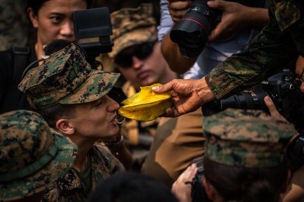A U.S. Marine takes a bite of star fruit as part of jungle survival training during exercise Cobra Gold at Ban Chan Krem, Feb. 14, 2019, in Chanta Buri, Kingdom of Thailand. (Matthew J. Bragg/Marine Corps)