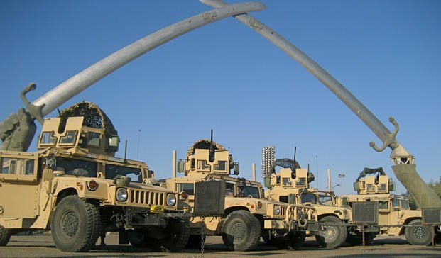 Humvees belonging to 1st Platoon, 153rd Military Police Company, appear near the Arc of Triumph (Crossed Swords) at the Green Zone in Baghdad, Dec. 12, 2007. (Brendan Mackie/Army National Guard)