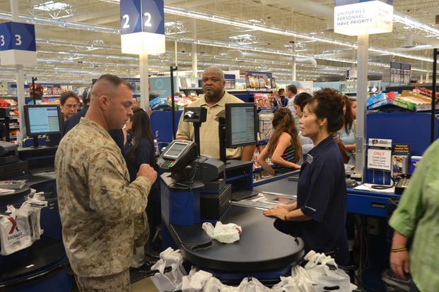 Patrons of the Army & Air Force Exchange Service move through the check out line during the grand opening of the new Fort Belvoir, Va., main exchange, on June 19, 2013.  Lt. Col. Antwan Williams/Army
