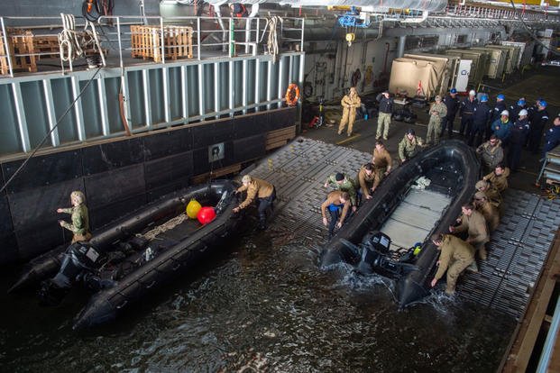 Sailors assigned to Explosive Ordnance Disposal Mobile Unit (EODMU) 2 prepare to launch a combat rubber raiding craft from the well deck of the Royal Fleet Auxiliary landing ship dock Mounts Bay during a mine countermeasures (MCM) task group experiment, March 23, 2019. (U.S. Navy photo/Danny Ray Nuñez Jr.) Sailors assigned to Explosive Ordnance Disposal Mobile Unit (EODMU) 2 prepare to launch a combat rubber raiding craft from the well deck of the Royal Fleet Auxiliary landing ship dock Mounts Bay during a mine countermeasures (MCM) task group experiment, March 23, 2019. (U.S. Navy photo/Danny Ray Nuñez Jr.)