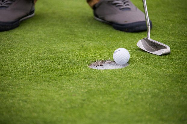 A golfer putts his ball into the hole during the Commanding General’s Cup Golf Challenge at Marine Corps Base Camp Pendleton, California, Oct. 2, 2018. (U.S. Marine Corps photo/Stephen Beard)