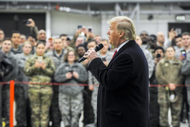 President Donald Trump and first lady Melania Trump pose for a photo with U.S. Airmen on Ramstein Air Base, Germany, Dec. 27, 2018. (U.S. Air Force/Staff Sgt. Timothy Moore)