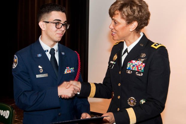 U.S. Army Lt. Gen. Nadja West, U.S. Army surgeon general and commander, U.S. Army Medical Command, presents a certificate of excellence to Brentwood High School sophomore and Air Force Junior ROTC Cadet Ahmad Perez at a school event in Brentwood Hamlet, Islip, New York, May 2, 2017. (U.S. Army photo/Jeremy Crisp)