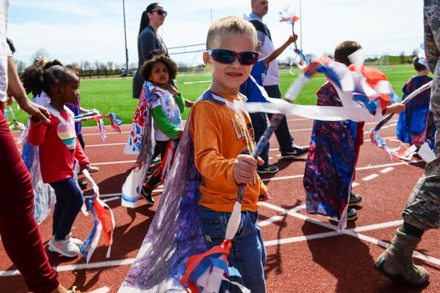 Children at the Child Development Center march in a Purple Up Parade to recognize the Month of the Military Child on Scott Air Force Base, Illinois. (U.S. Air Force/Erica Fowler)