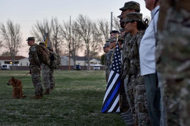 Participants of the 2019 377th Security Forces Squadron Suicide Awareness Ruck March stand in formation at Kirtland Air Force Base, New Mexico, March 29, 2019. The ruck march was created to support The Brave Badge Initiative Facebook page. The Facebook page was created due to the increased rates in suicide in the security forces career field in the past year and aims to give Defenders another place to go to when they are struggling with mental health issues. (Austin J. Prisbrey/U.S. Air Force)