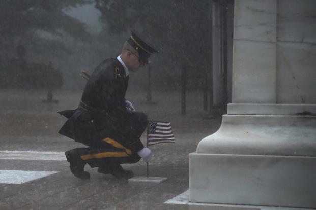 A soldier of the 3d U.S. Infantry Regiment (The Old Guard) stands in front of the Tomb of the Unknown Soldier during a severe storm for Flags In at Arlington National Cemetery, May 23, 2019. Flags In is an annual military operation carried out by The Old Guard before Memorial Day weekend in which soldiers plant over 245,000 U.S. flags at the graves of Arlington National Cemetery. (Maryam Treece/U.S. Army)