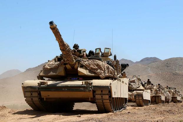 An M1 tank of the 3rd Infantry Division’s 2nd Armored Brigade Combat Team drives in a convoy with other armored vehicles on May 7, 2019, at the National Training Center at Fort Irwin, California. Matthew Cox/Military.com